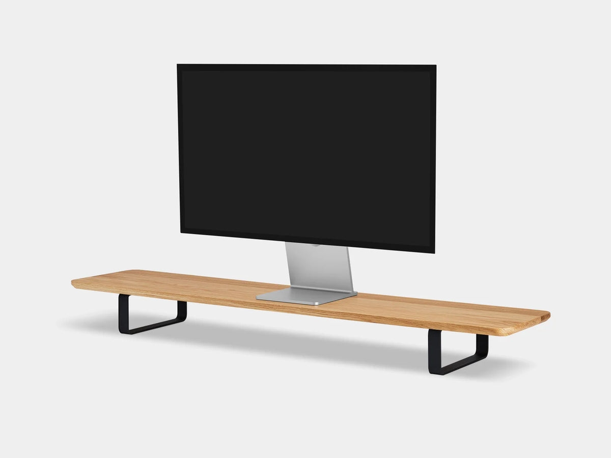 Oak desk shelf with black legs and a monitor on top, three-quarter view