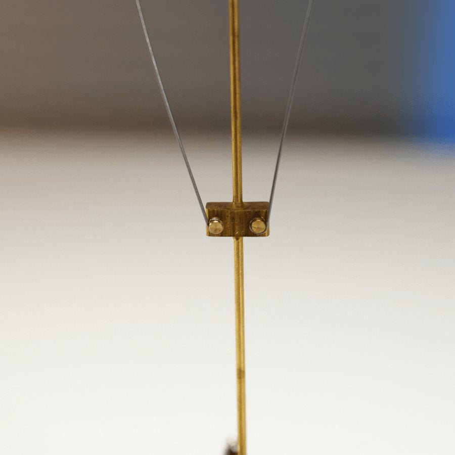 A small brass collar on the rod with two thin wires running up.