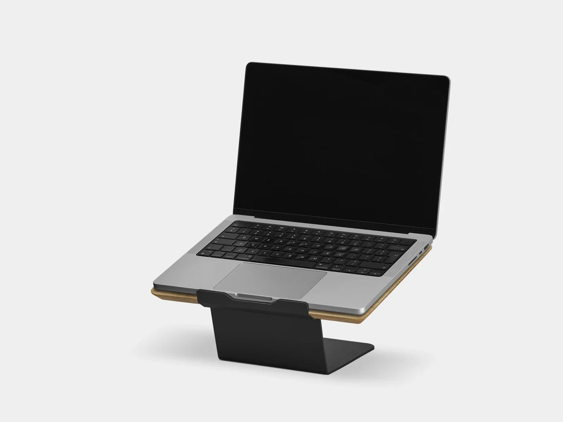 Oak laptop riser holding a laptop, three-quarter view