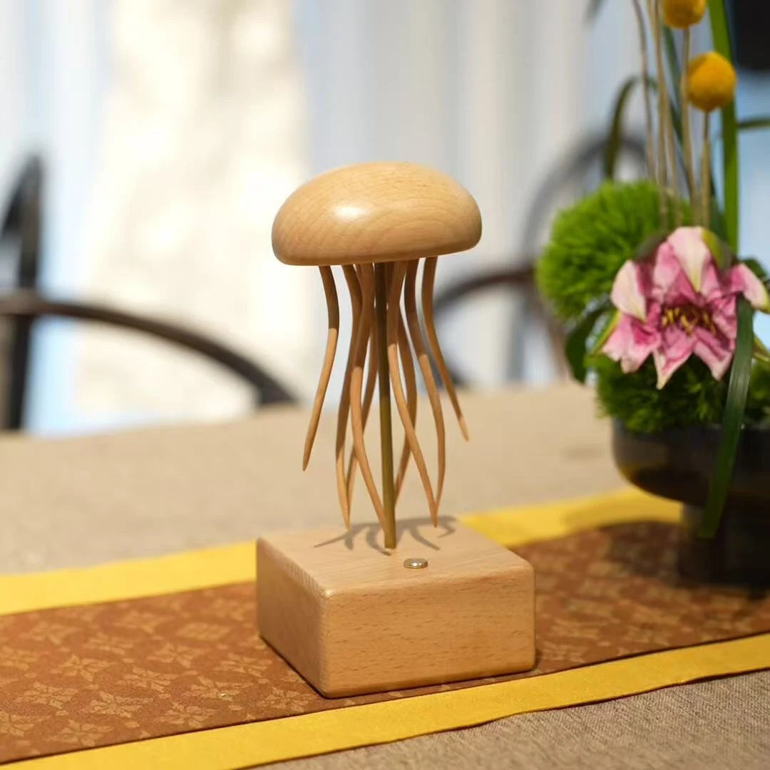 Jellyfish automaton on a woven table runner with flowers and a chair behind.