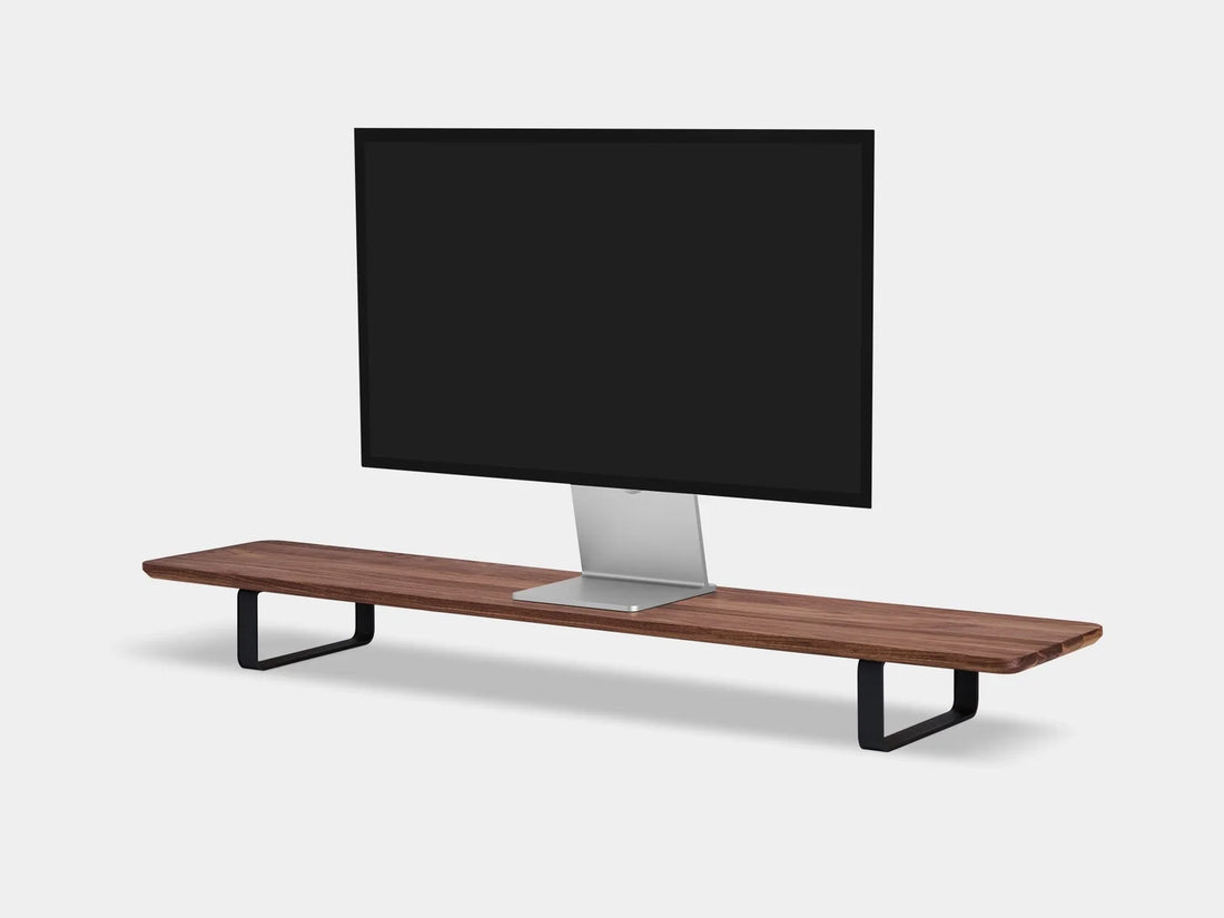 Walnut desk shelf with black legs and a monitor on top, three-quarter view