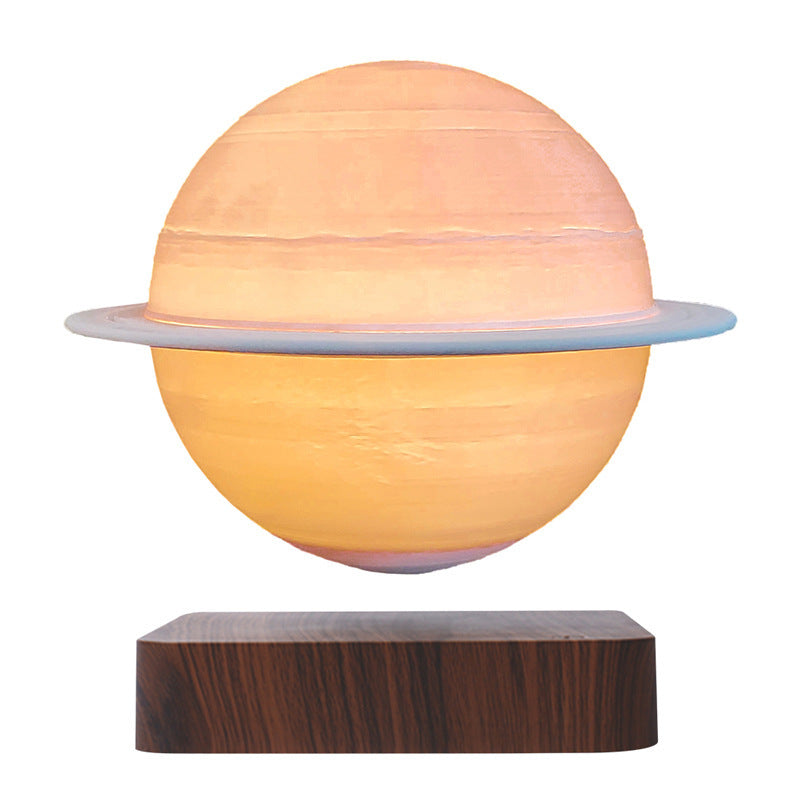 Saturn globe with its ring floating above a deep wood-grain base