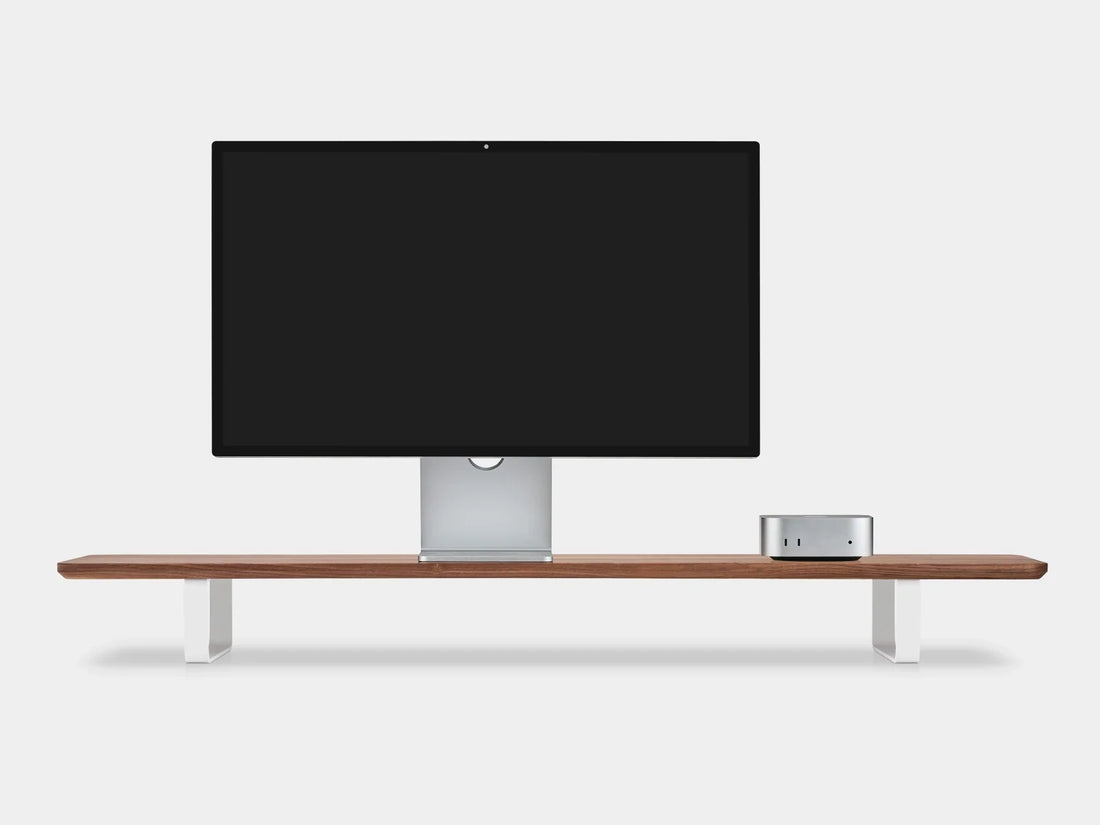 Walnut desk shelf with white legs holding a monitor and a small desktop computer