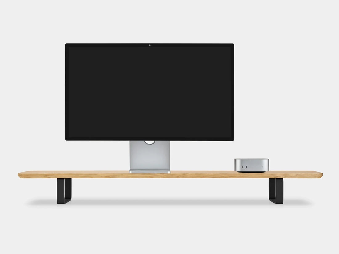 Oak desk shelf with black legs holding a monitor and a small desktop computer, front view