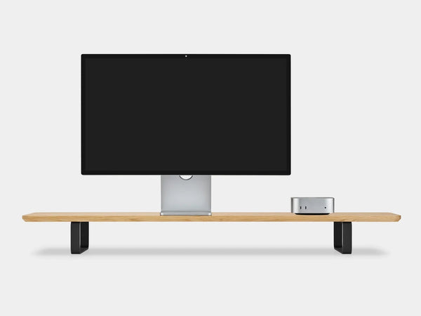 Oak desk shelf with black legs holding a monitor and a small desktop computer, front view