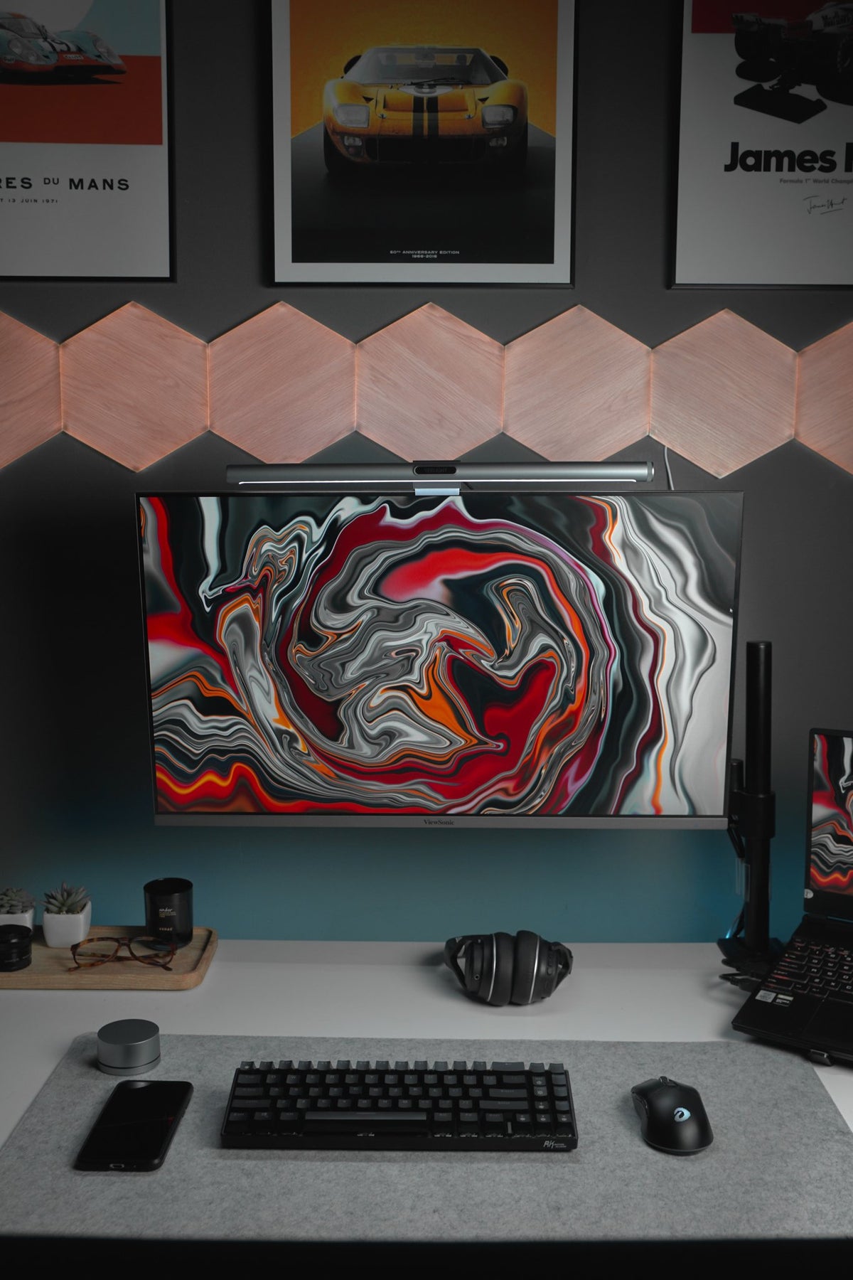 Dark desk with red wave screens, hexagon lights and racing posters
