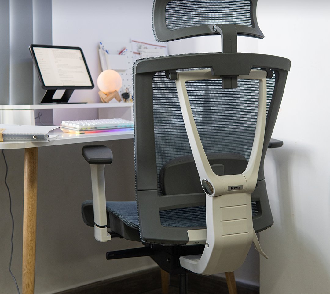 Gray ergonomic chair at a white study desk