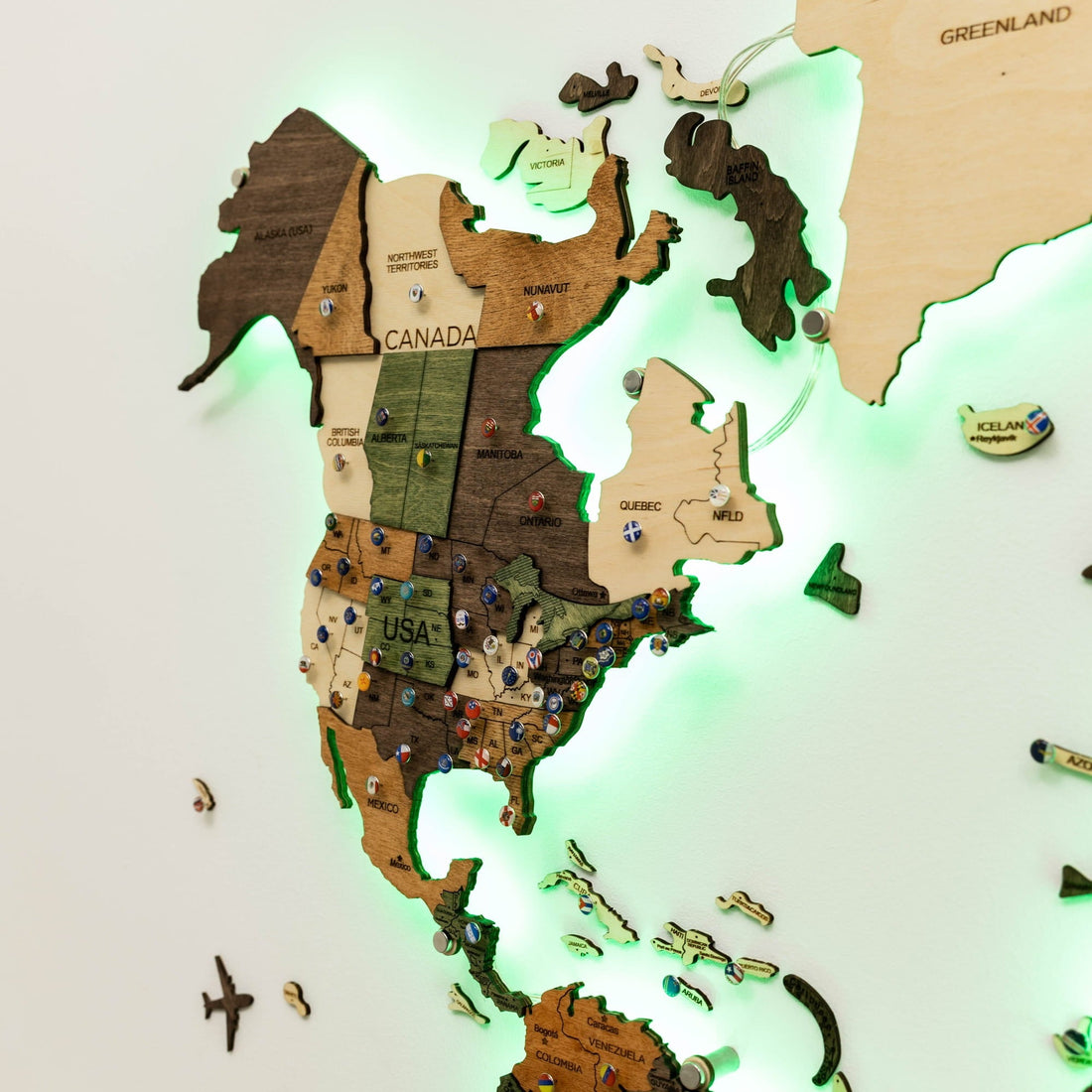 North America on the wooden map with a green glow around the layered country pieces