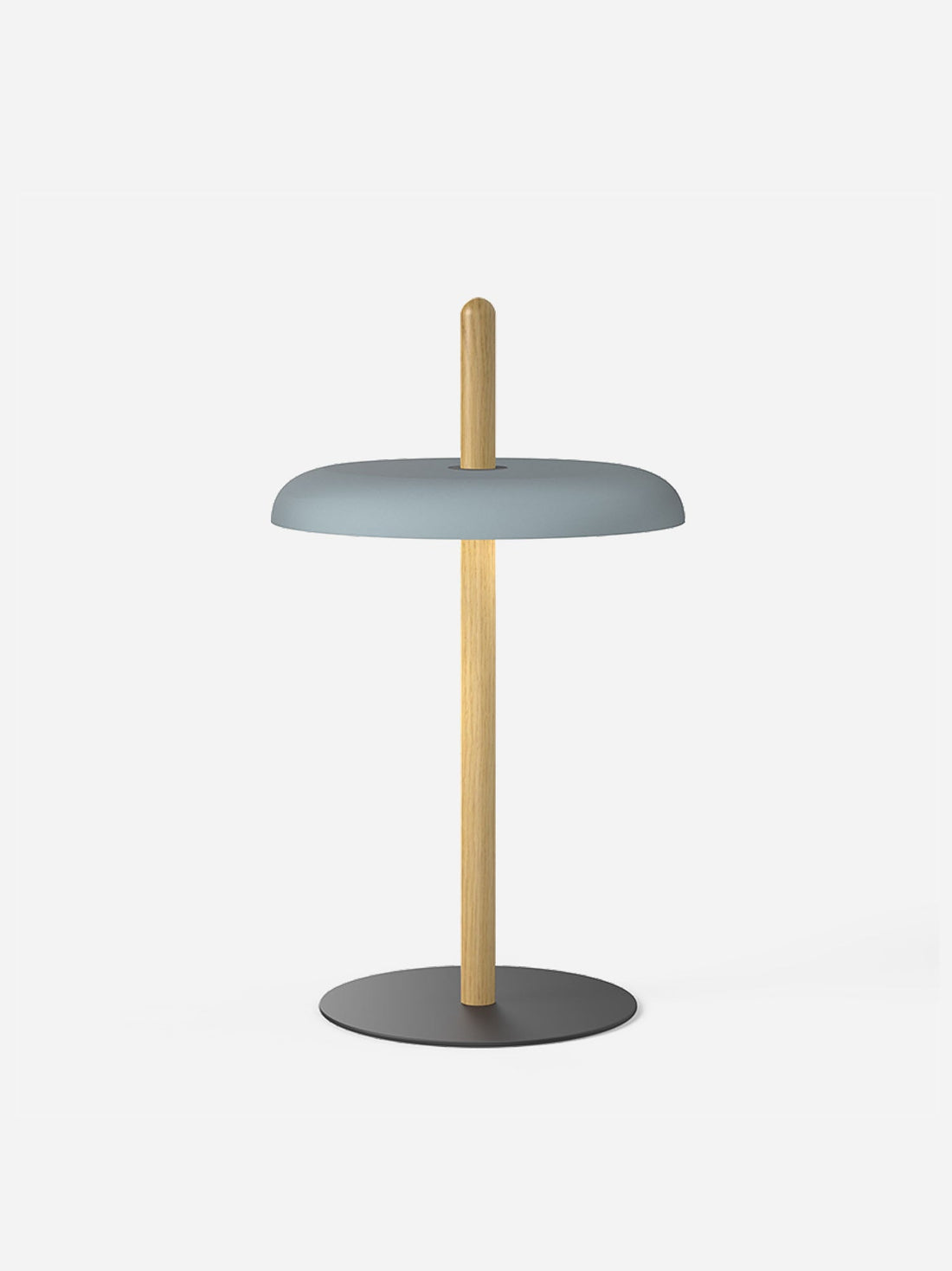 A slate blue shade on the oak post of the Nivel lamp against a light background