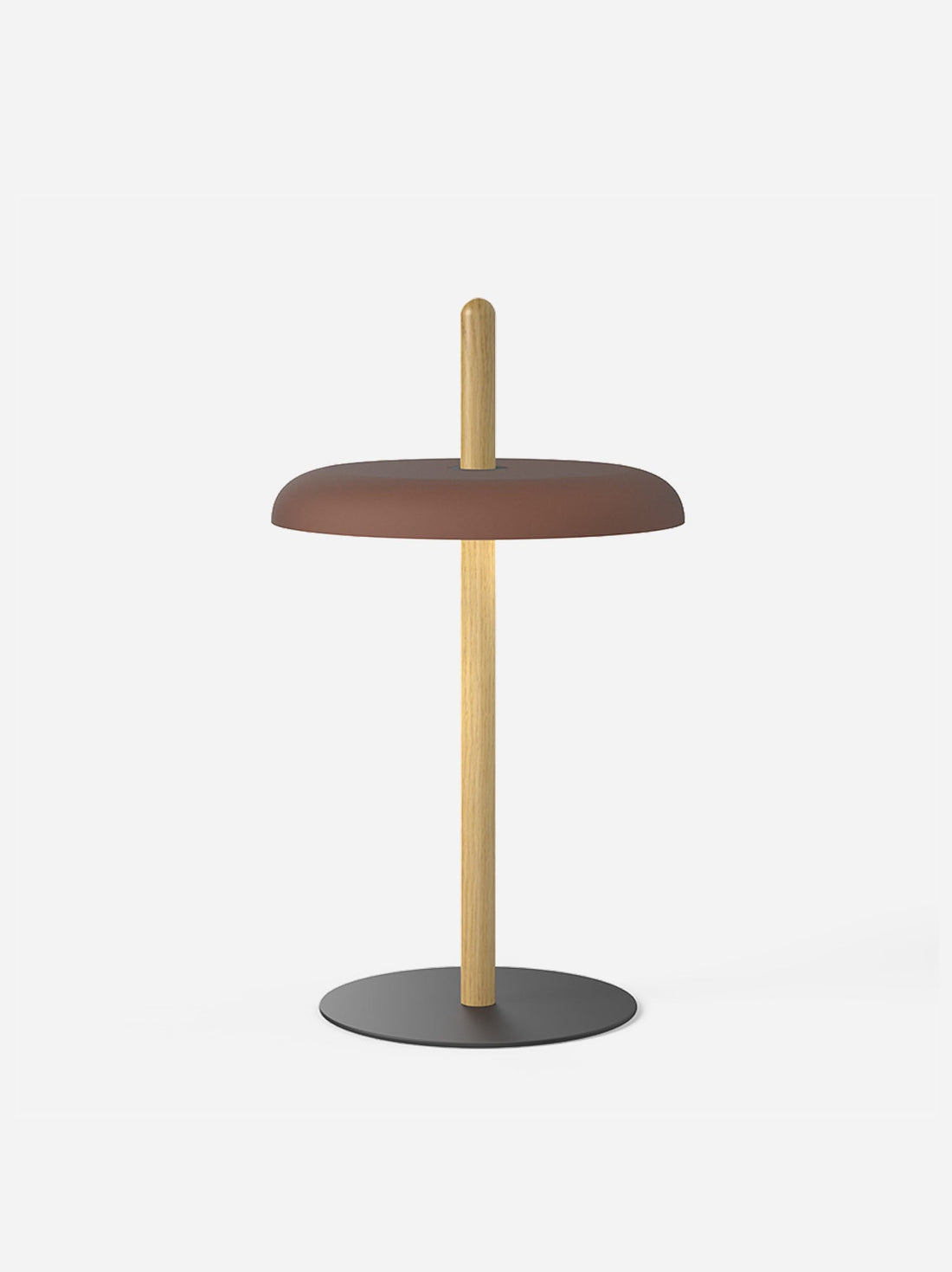 A terracotta-brown shade on the oak post of the Nivel lamp against a light background