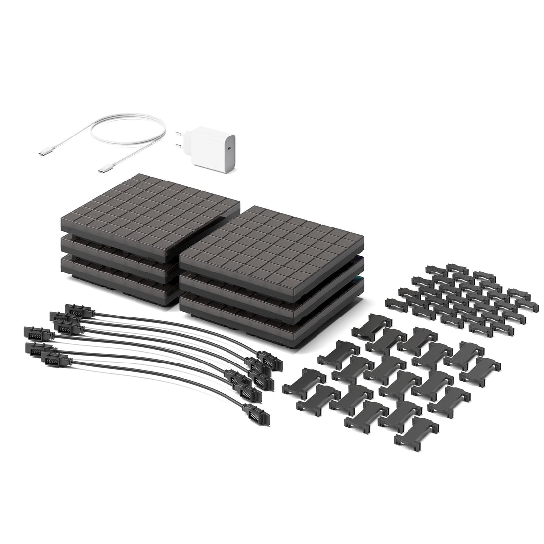 Kit contents laid out: dark panels, connector cables, clips, a power adapter and a USB cable