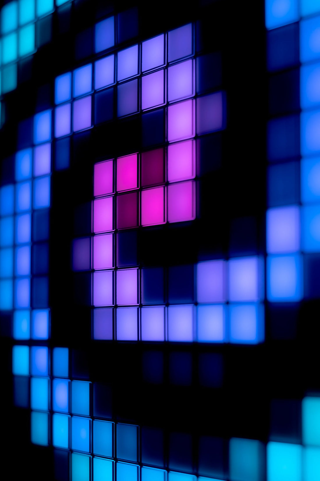 Close-up of blue, violet and pink pixel patterns on the panel grid