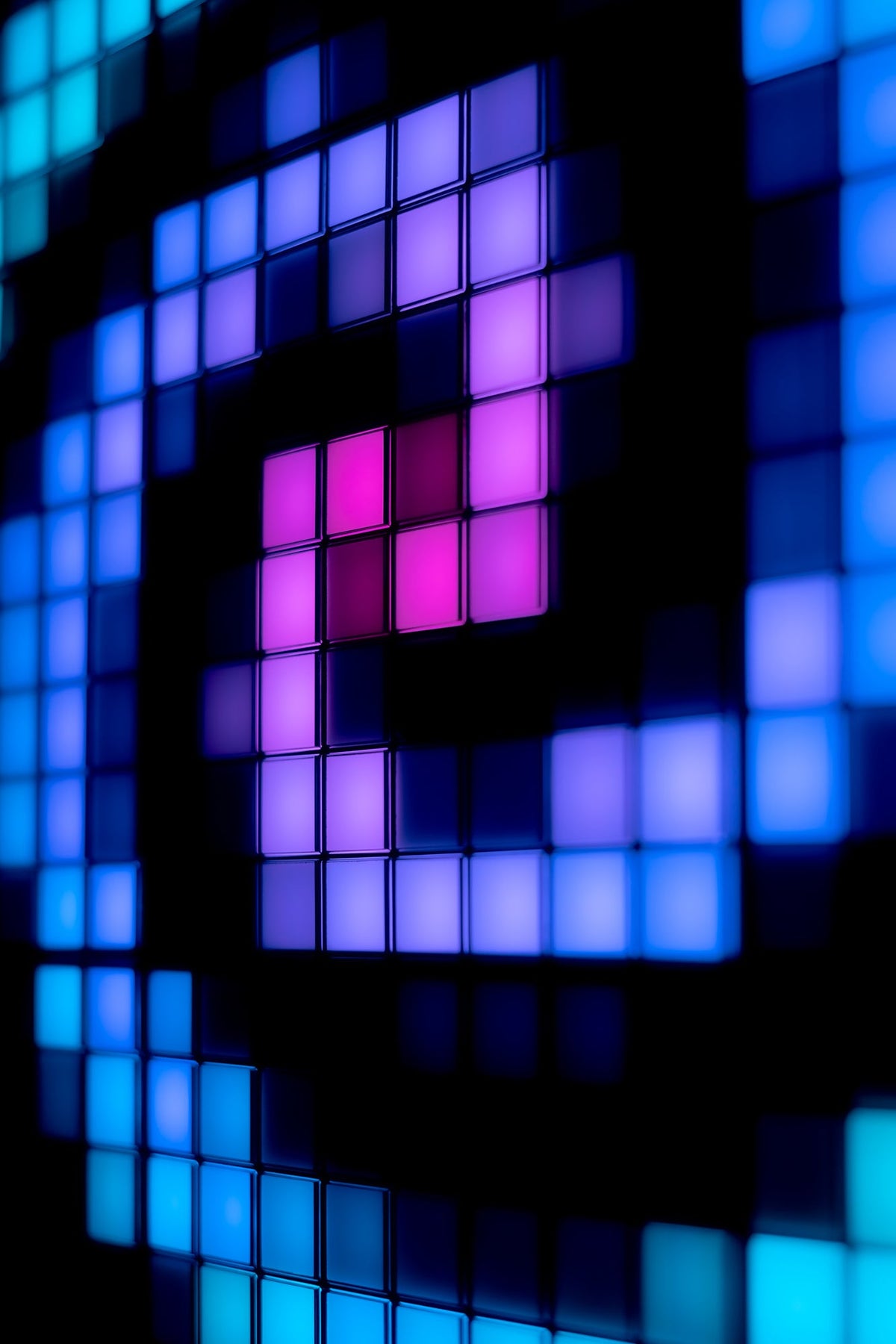 Close-up of blue, violet and pink pixel patterns on the panel grid