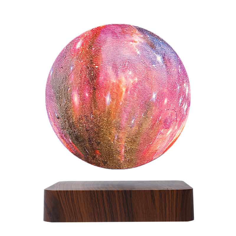 Red and pink galaxy globe floating above a deep wood-grain base