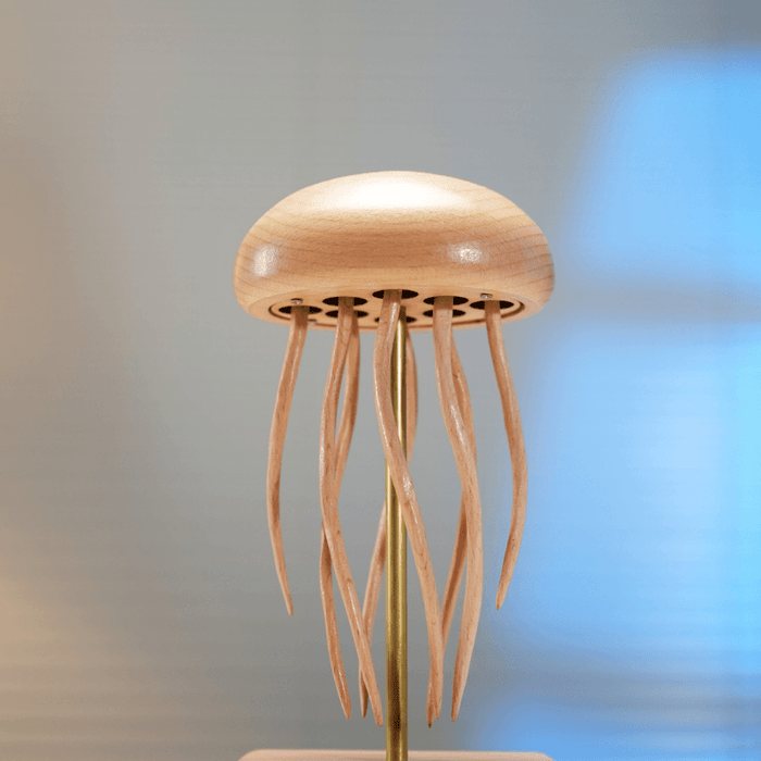 Under the bell, where the thin tentacles hang from the dome around a brass rod.