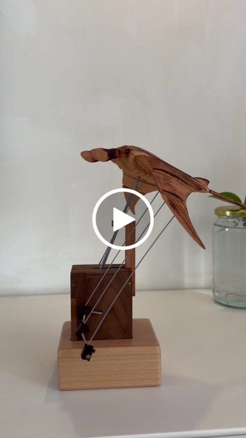 Betty O.: Manta ray automaton on a white sideboard in front of a pale wall, wings out on thin wires, from an owner clip.