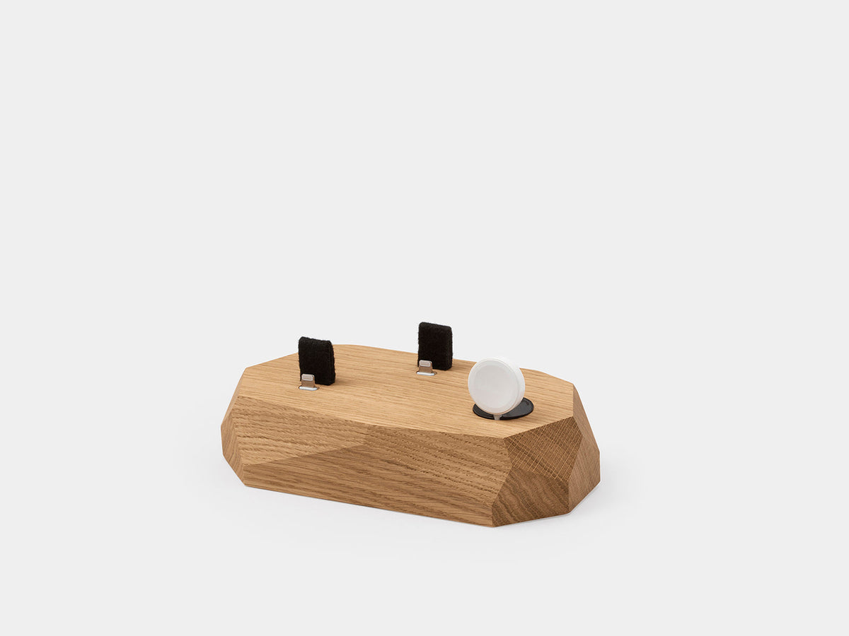 Top view of the oak dock showing connector slots and the watch puck