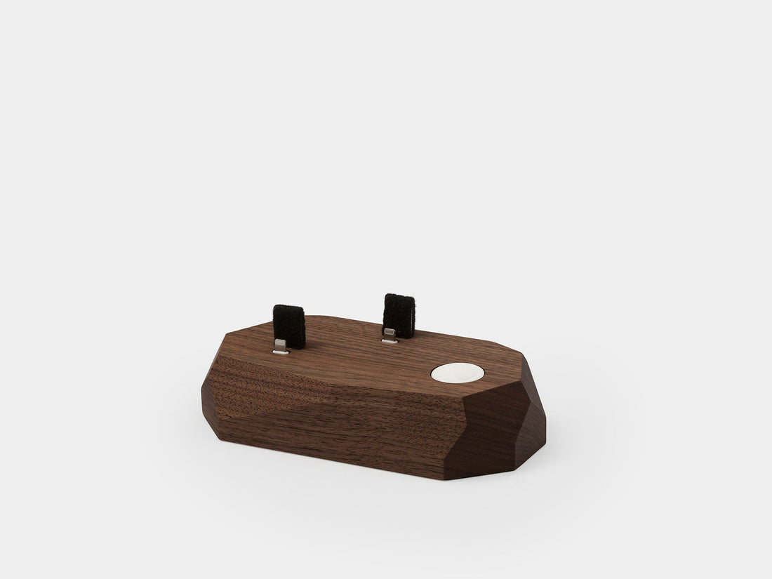 Top view of the walnut dock showing connector slots and the watch puck